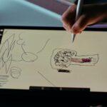 person holding white printer paper with drawing